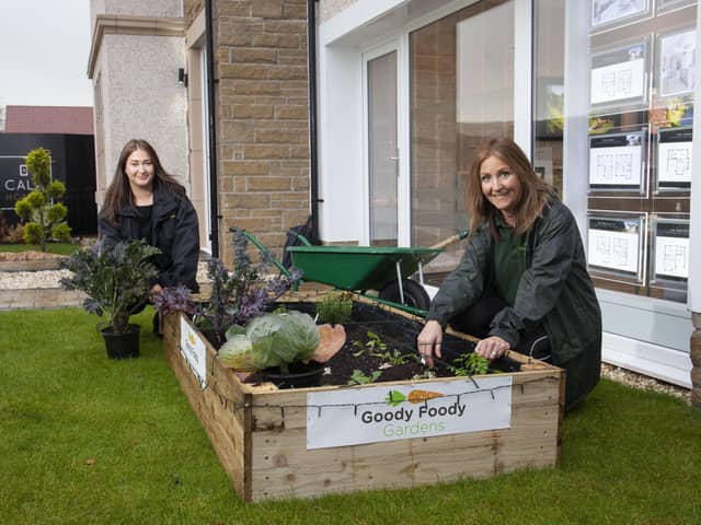 Laura Molloy, Founder of Goody Foody Gardens, and Lisa Curtis, Sales Advisor at CALA Homes (West) at one of the newly installed showhome garden veg patches.