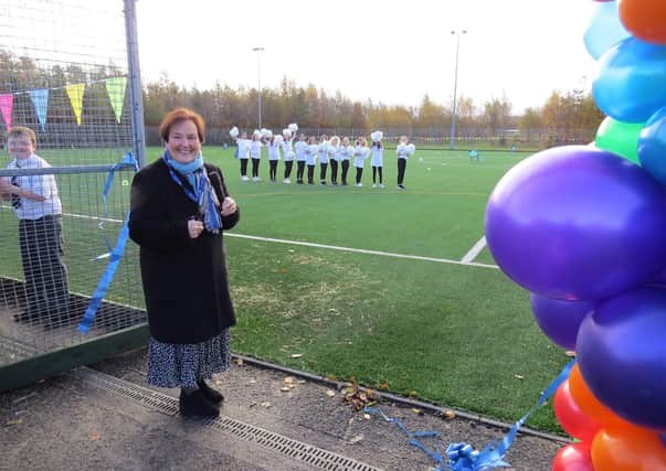 Mhairi Shaw cutting the ribbon to the new pitch.