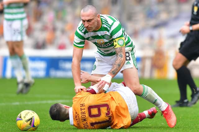 Celtic's Scott Brown colliding with Motherwell's Liam Polworth. (Photo by Mark Runnacles/Getty Images)