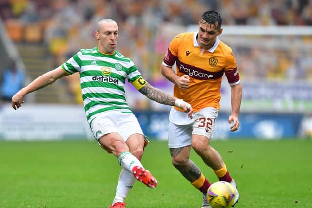 Celtic's Scott Brown being challenged by Motherwell's Tony Watt at Fir Park. (Photo by Mark Runnacles/Getty Images)