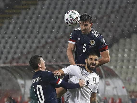 Motherwell and Scotland ace Declan Gallagher towers above Serbia's Aleksandar Mitrovic (Pic courtesy of Getty Images)