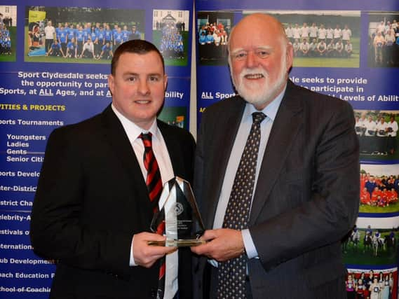 Jamie McKenzie is pictured after receiving his Clydesdale Sports Council 'Coach of the Year' prize from Councillor Hamish Stewart at the 2016 Sports Personality Awards (Pic by John Prior)