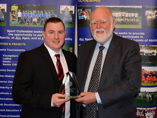 Jamie McKenzie accepts a Coach of the Year prize from Councillor Hamish Stewart at the 2016 Clydesdale Sports Council Sports Personality of the Year Awards