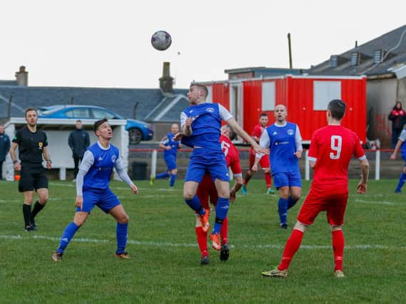 Carluke Rovers' Jonathon Wilson challenges for a high ball at Neilston on Saturday (Pic by Kevin Ramage)