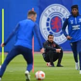 Rangers' Dutch manager Giovanni van Bronckhorst (C) watches Rangers' Welsh midfielder Aaron Ramsey (L) and Rangers' Nigerian midfielder Joseph Ayodele-Aribo at a team training session at the Rangers Training Centre in Glasgow ahead of their Europa League final football match against Eintracht Frankfurt on May 18th. Photo by ANDY BUCHANAN/AFP via Getty Images