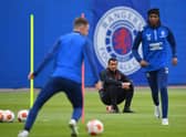 Rangers' Dutch manager Giovanni van Bronckhorst (C) watches Rangers' Welsh midfielder Aaron Ramsey (L) and Rangers' Nigerian midfielder Joseph Ayodele-Aribo at a team training session at the Rangers Training Centre in Glasgow ahead of their Europa League final football match against Eintracht Frankfurt on May 18th. Photo by ANDY BUCHANAN/AFP via Getty Images