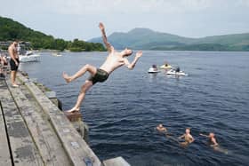 Swimmers jumping into Loch Lomond from a pier at Luss Picture: Andrew Milligan/PA Wire