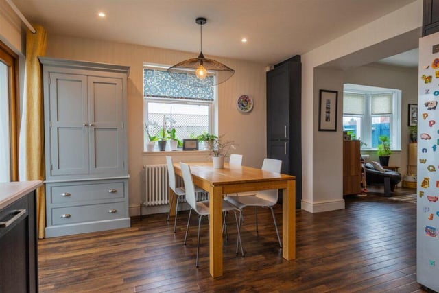 The dining space leads on to a conservatory.