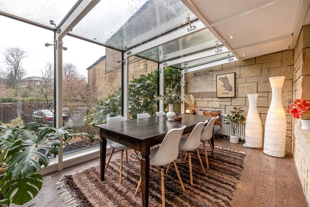 The glass extension is being used as a dining room.