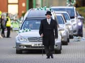 Celtic fans pay respect as Former Celtic player Bertie Auld's funeral cortege passes Celtic Park. Picture: Ross MacDonald/SNS Group