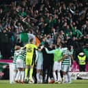 Celtic players celebrate in front of their fans after clinching the Scottish Premiership title with a 1-1 draw against Dundee United at Tannadice. (Photo by Alan Harvey / SNS Group)