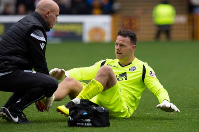 Trevor Carson having a previous injury looked at while playing against Hearts in 2018. Photo: Graeme Hunter