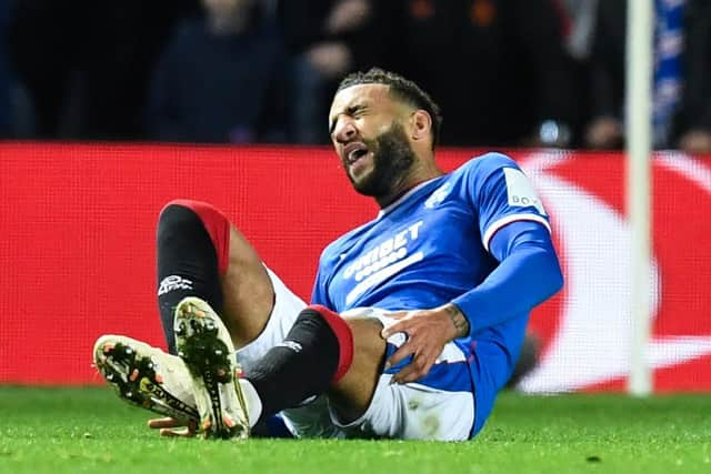 Rangers' Connor Goldson goes down in agony during the Liverpool match.