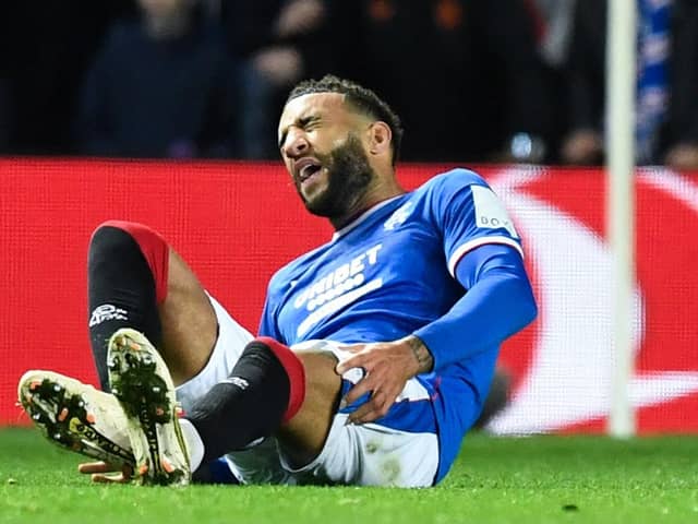 Rangers' Connor Goldson goes down in agony during the Liverpool match.