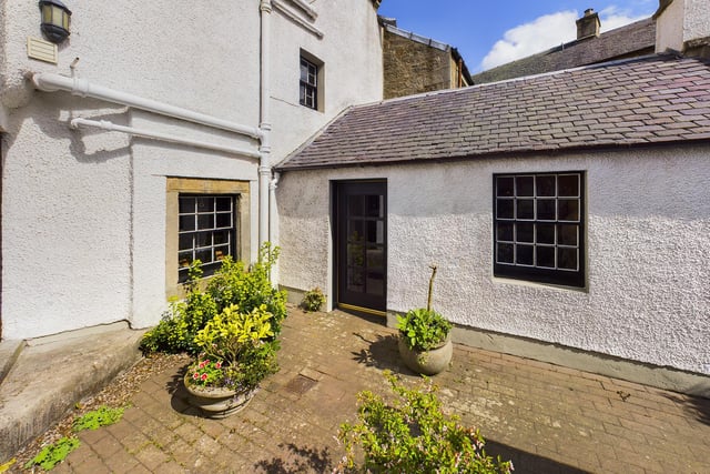 A well-tended courtyard garden at the rear also houses a stone outbuilding, which provides ample garden storage