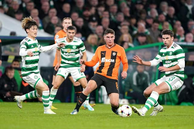 Celtic's Kyogo Furuhashi, left, and Greg Taylor close down Shakhtar's Heorhiy Sudakov in possession.