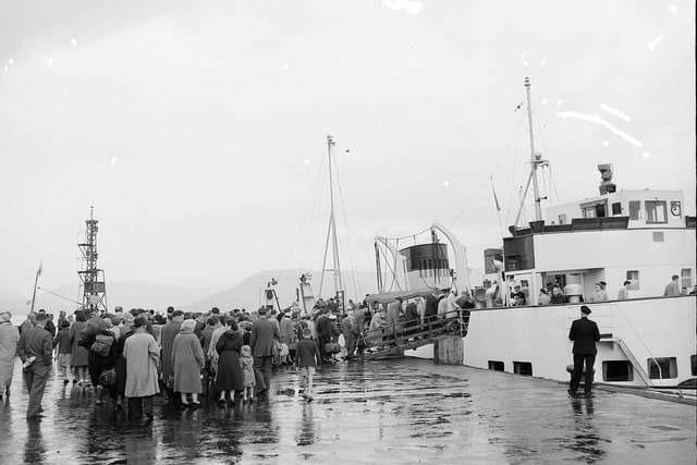 Holiday makers board the steamer at Gourock for Dunoon in the rain during the Glasgow Fair holiday in 1959.