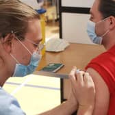 Vaccinator Steven Dawson giving Sam Jamieson his 2nd Covid19 vaccine at the Ally McCoist Sport Centre in East Kilbride. Covid19, May 2021