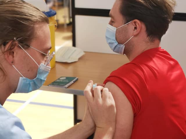 Vaccinator Steven Dawson giving Sam Jamieson his 2nd Covid19 vaccine at the Ally McCoist Sport Centre in East Kilbride. Covid19, May 2021