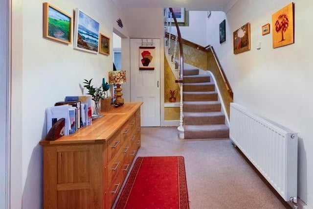 Guests are welcomed in to a spacious hallway with a decoratively ornate staircase leading to the first floor