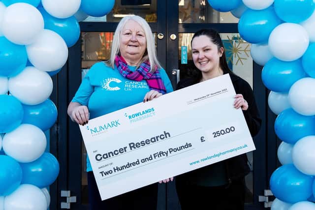 Janice Coulter receives the Cancer Research UK cheque from Ruth Clark.
