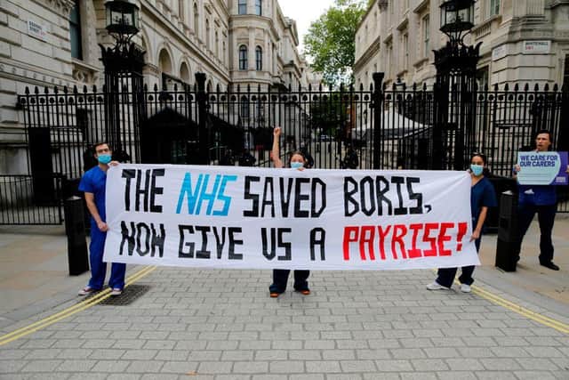 Nurses who work at central London hospitals protest with placards outside Downing Street on May 13, calling for improved conditions and pay for nursing staff on the occasion of International Nurses Day 2020 during the COVID-19 pandemic (Photo: TOLGA AKMEN/AFP via Getty Images)