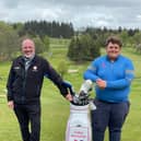Balmore Golf Club's Chris Maclean is presented with a new golf club by former club pro Dougie McCluskey
