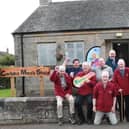 Carluke Men's Shed members celebrate after moving into their new premises in the town.