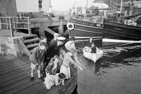 Children fishing during the Glasgow Fair Holidays in 1956.