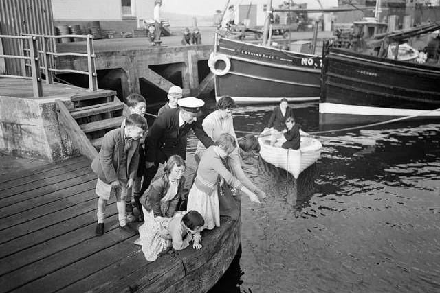 Children fishing during the Glasgow Fair Holidays in 1956.