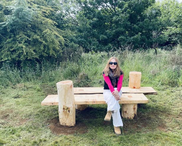 Justyna Stanka is pictured sitting on her competition-winning bench in Fortmonthills Woodland, Glenrothes.