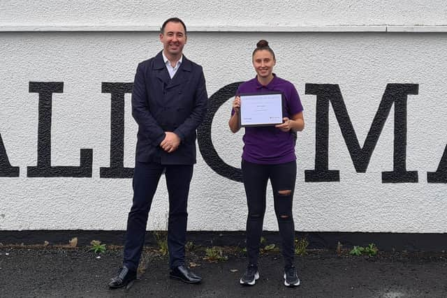 Keith Thom, NFU Mutual Agent for Strathaven and Lanark, presents Sammy Jo Smith with her prize