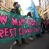 Climate activists from the Extinction Rebellion group demonstrate outside the offices of JP Morgan in Glasgow.