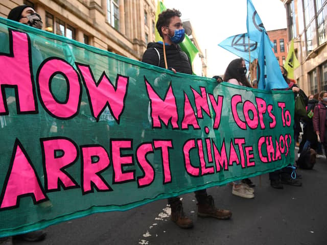 Climate activists from the Extinction Rebellion group demonstrate outside the offices of JP Morgan in Glasgow.