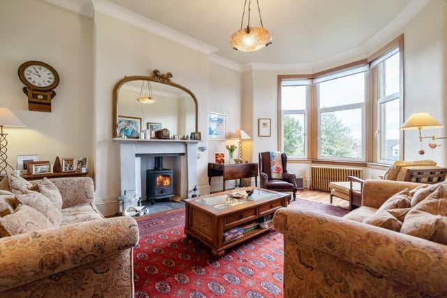 The lounge has a beautiful bay window and a feature fireplace.