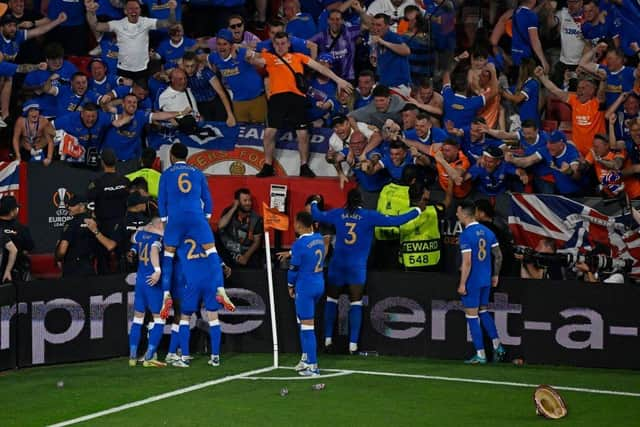 Players celebrate with fans after Rangers' Nigerian midfielder Joe Aribo scored the first goal of the UEFA Europa League final football match between Eintracht Frankfurt and Glasgow Rangers at the Ramon Sanchez Pizjuan stadium in Seville on May 18, 2022. (Photo by PIERRE-PHILIPPE MARCOU/AFP via Getty Images)