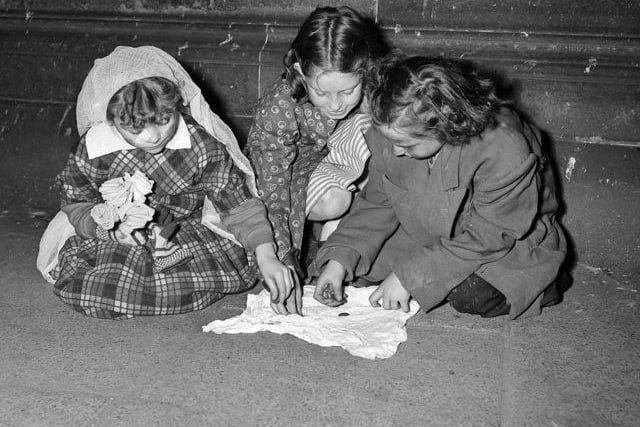 These children 'turn out' their guising money in 1951.