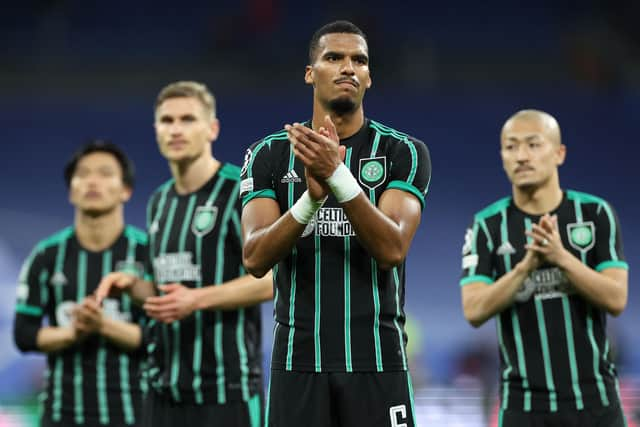 Moritz Jenz and the rest of the Celtic players applaud the travelling fans at the end of the 5-1 defeat to Real Madrid in the Bernabeu. (Photo by THOMAS COEX/AFP via Getty Images)