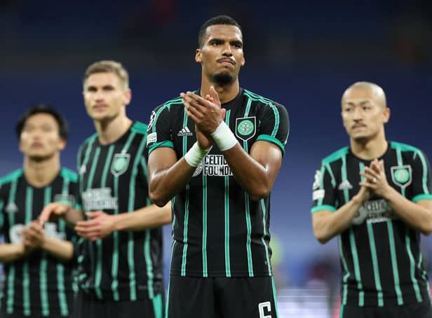 <p>Moritz Jenz and the rest of the Celtic players applaud the travelling fans at the end of the 5-1 defeat to Real Madrid in the Bernabeu. (Photo by THOMAS COEX/AFP via Getty Images)</p>