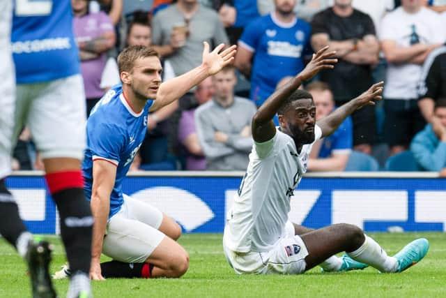 Ross County's Jordy Hiwula appeals to the referee after he is brought down by Rangers defender James Sands. (Photo by Rob Casey / SNS Group)