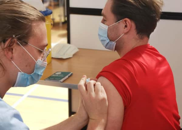 Vaccinator Steven Dawson giving Sam Jamieson his 2nd Covid19 vaccine at the Ally McCoist Sport Centre in East Kilbride. Covid19, May 2021