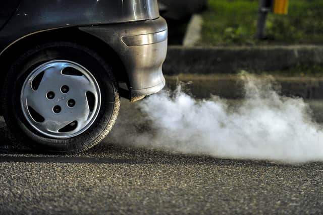 A car belching out exhaust fumes