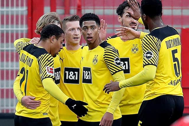 Dortmund's German forward Marco Reus with Jude Bellingham and team-mates (Photo by RONNY HARTMANN/AFP via Getty Images)