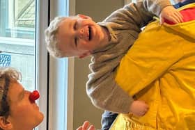 Archie plays the Clowndoctors during a Play and Connect session