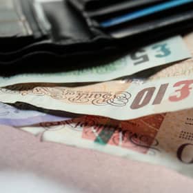 Stock picture Fifty, Twenty, Ten, and Five pound notes in a wallet.