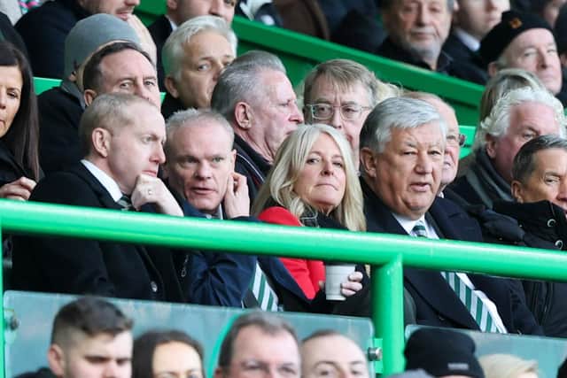 Former Celtic chief executive Peter Lawwell (right) watches a match at Celtic Park with his son Mark (left).