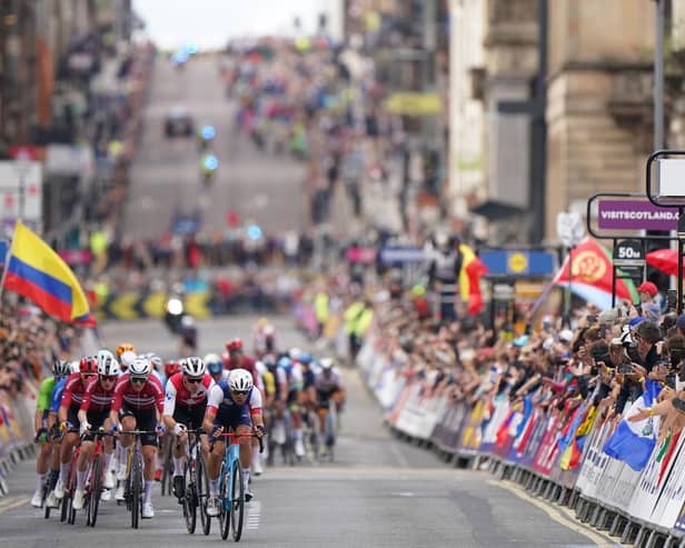 France's Benoit Cosnefroy leads a group of riders along George Square in Glasgow during day four of the 2023 UCI Cycling World Championships in Glasgow. Image: Tim Goode/PA Wire.