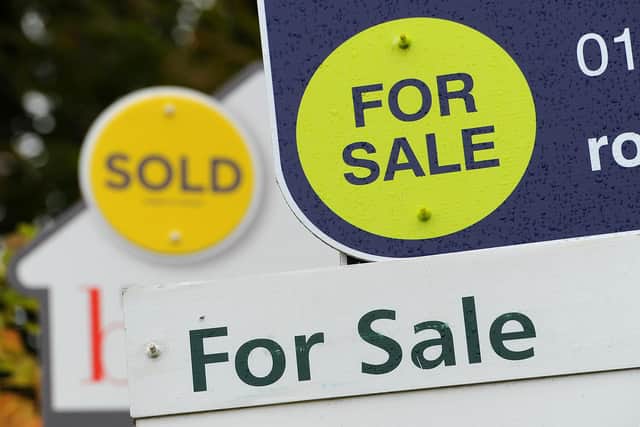 General view of estate agents signs outside a block of flats in Basingstoke, Hampshire.
