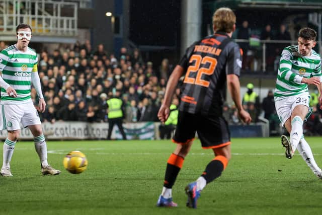 Celtic's Matt O'Riley (R) has a strike at goal during a Scottish Cup match between Dundee United and Celtic.