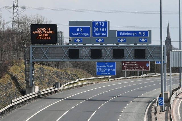 A sign above Glasgow's M8 read 'Avoid travel where possible'.